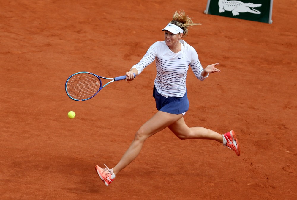 Maria Sharapova of Russia returns the ball during the women's singles fourth round match against Lucie Safarova of Czech Republic at 2015 French Open tennis tournament at Roland Garros, in Paris, France, on June 1, 2015. Sharapova lost 0-2 and was disqualified for the quarterfinal.