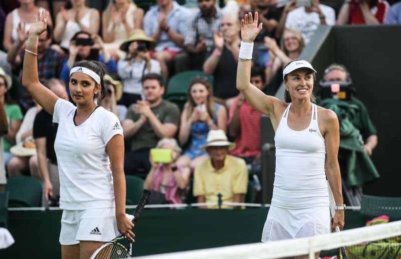 Martina Hingis  of Switzerland and Sania Mirza of India greet the audience