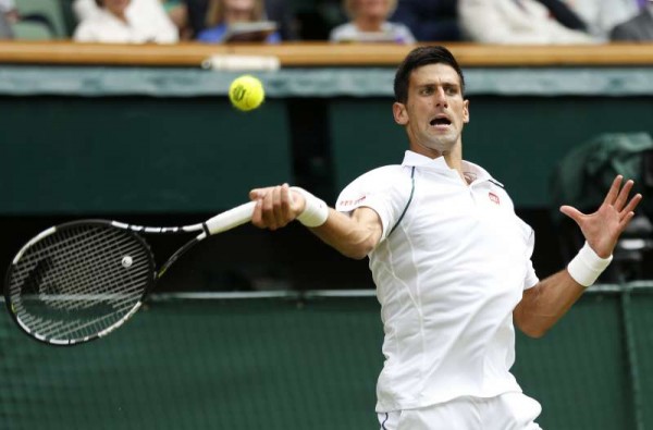 Novak Djokovic of Serbia returns a ball during men's singles final against Roger Federer of Switzerland at the 2015 Wimbledon Championships in Wimbledon, southwest London, July 12, 2015. 