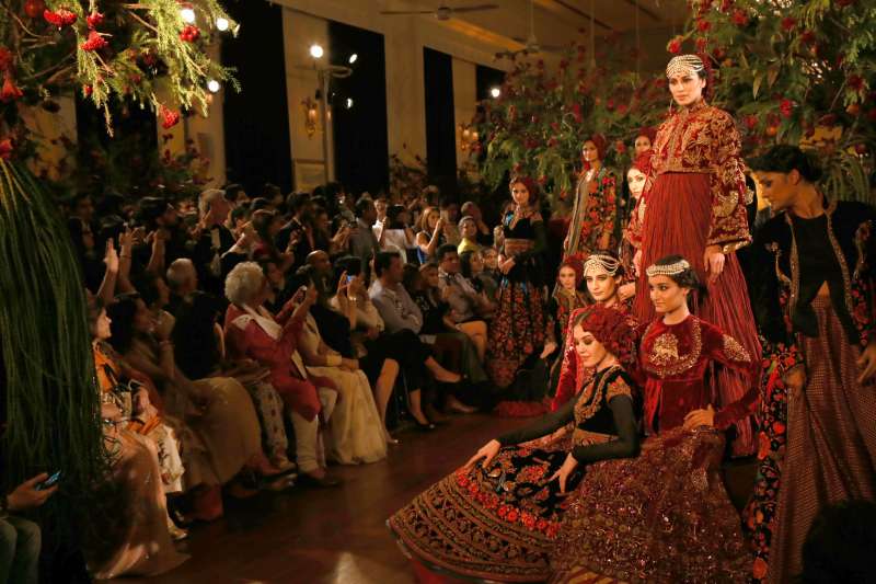 Models walk on the ramp with designer Rohit Bal during the Amazon India Couture Week 2015, in New Delhi.