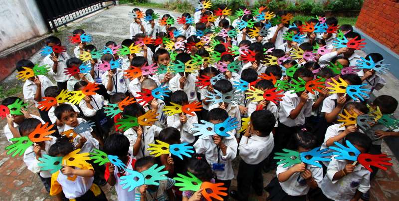 Nepalese children cheer with handmade masks during an event marking the Nepalese Children's Day in Kathmandu, Nepal, Sept. 15, 2015. Nepal observed its 26th Children's Day with various events organized nationwide