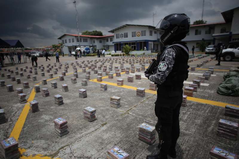 A member of the National Police stands guard next to packages of drugs during a press conference in Panama City, capital of Panama, on Sept. 14, 2015. The National Police seized 3.2 tons of drugs and arrested 16 people during the operation that took place during the weekend, according to information of the National Police.