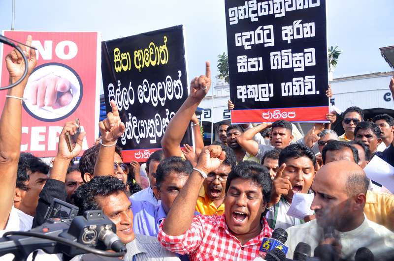 People shout slogans during a protest to call on Sri Lankan Prime Minister Ranil Wickremesinghe not to sign a trade agreement with India in Colombo, Sri Lanka, Sept. 14, 2015. Hundreds of people participated in a protest in Sri Lanka on Monday urging the new government to refrain from signing the Comprehensive Economic Partnership Agreement (CEPA) with India.