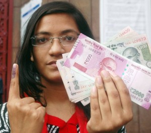 Kolkata: A woman shows her finger marked with indelible ink at a bank after exchanging demonetised Rs 1000 and 500 notes in Kolkata on Nov 17, 2016. (Photo: Kuntal Chakrabarty/IANS)