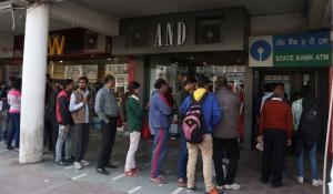 People queue up outside an ATM to withdraw cash in New Delhi (Photo: IANS)