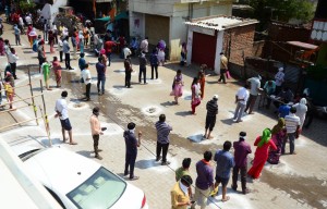 Nagpur: People practise social distancing as they queue up outside a rationshop to collect three-months ration distributed free of cost among the marginalised groups during the 21-day nationwide lockdown (that entered its 8th day) imposed as a precautionary measure to contain the spread of coronavirus, in Nagpur on Apr 1, 2020. (Photo: IANS)