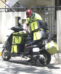 Bengaluru: A delivery boy busy sorting food parcels for handing them to the prospective consumers on Day 6 of the 21-day countrywide lockdown imposed to contain the spread of novel coronavirus, in Bengaluru on March 30, 2020. (Photo: IANS)