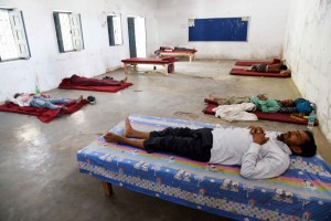 Patna: Migrant laborers take a nap at a relief camp set up at the College of Commerce, Arts & Science during a 21-day nationwide lockdown imposed to contain the spread of novel coronavirus, in Patna on March 30, 2020. (Photo: IANS)